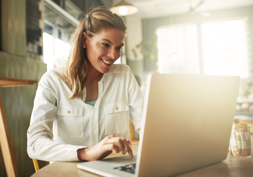 Woman, laptop and coffee shop for online news, freelancer and website for article research. Female person, restaurant and reporter to review bistro service or hospitality, typing column and media