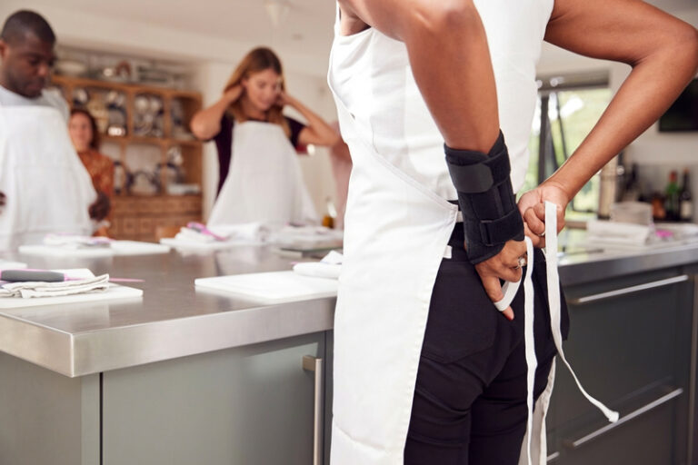 Restaurant worker tying an apron
